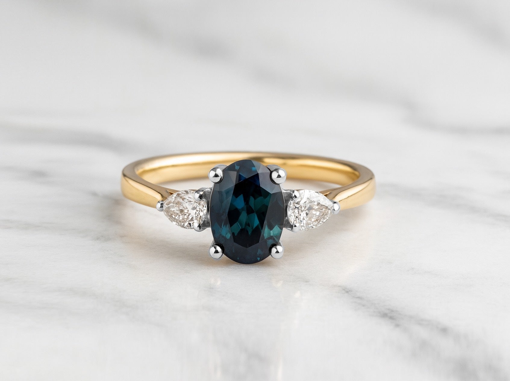 Oval cut Teal sapphire with pear diamonds