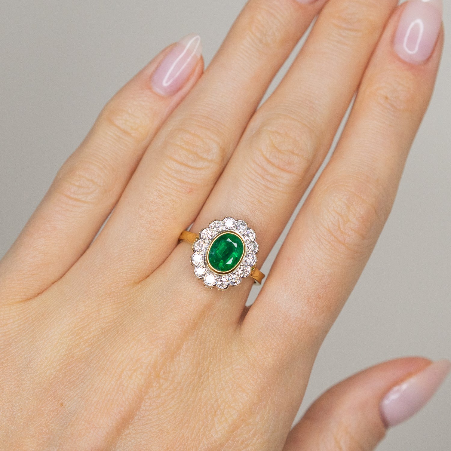 1.90ct Oval Emerald Ring with Bezel and Diamond Halo