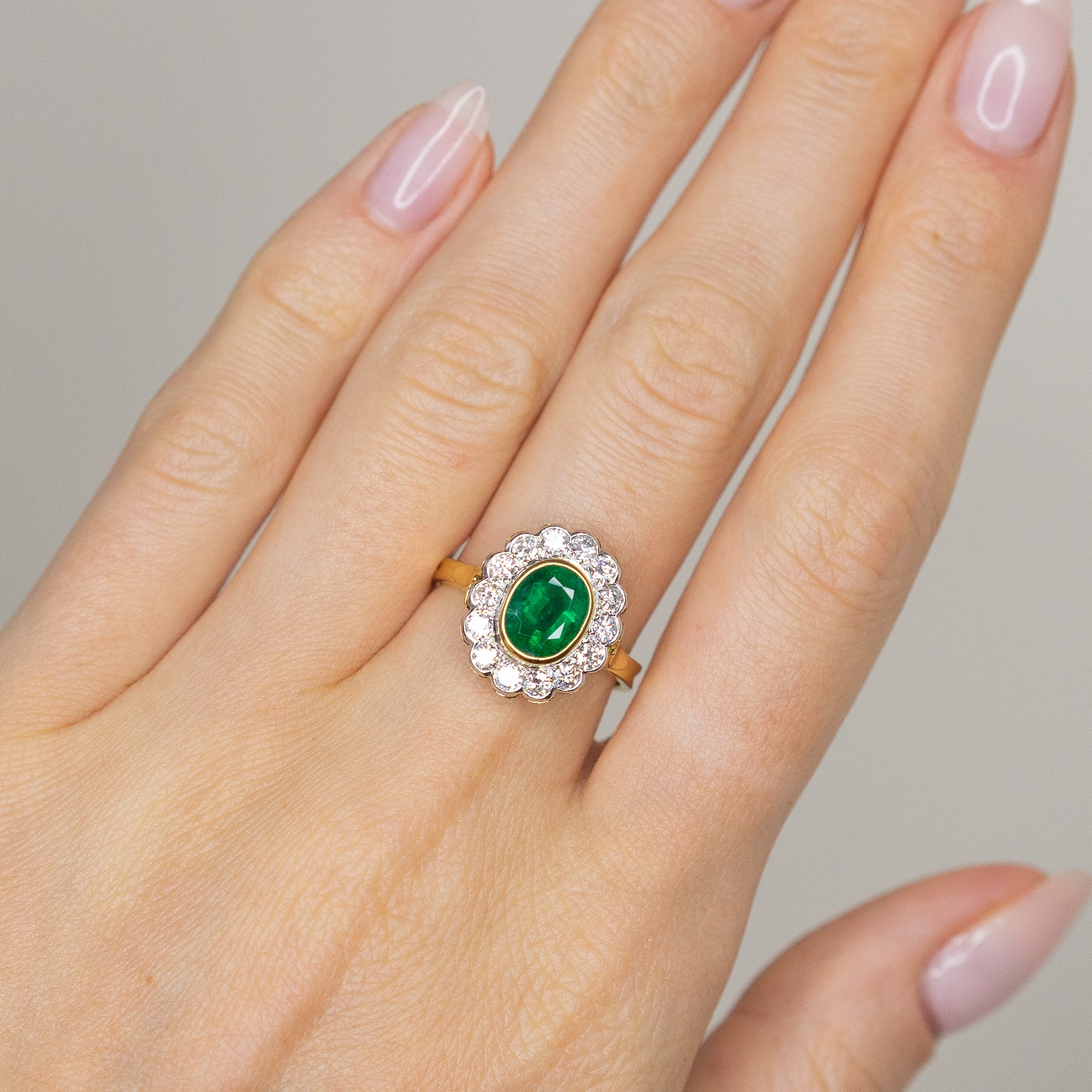 1.90ct Oval Emerald Ring with Bezel and Diamond Halo