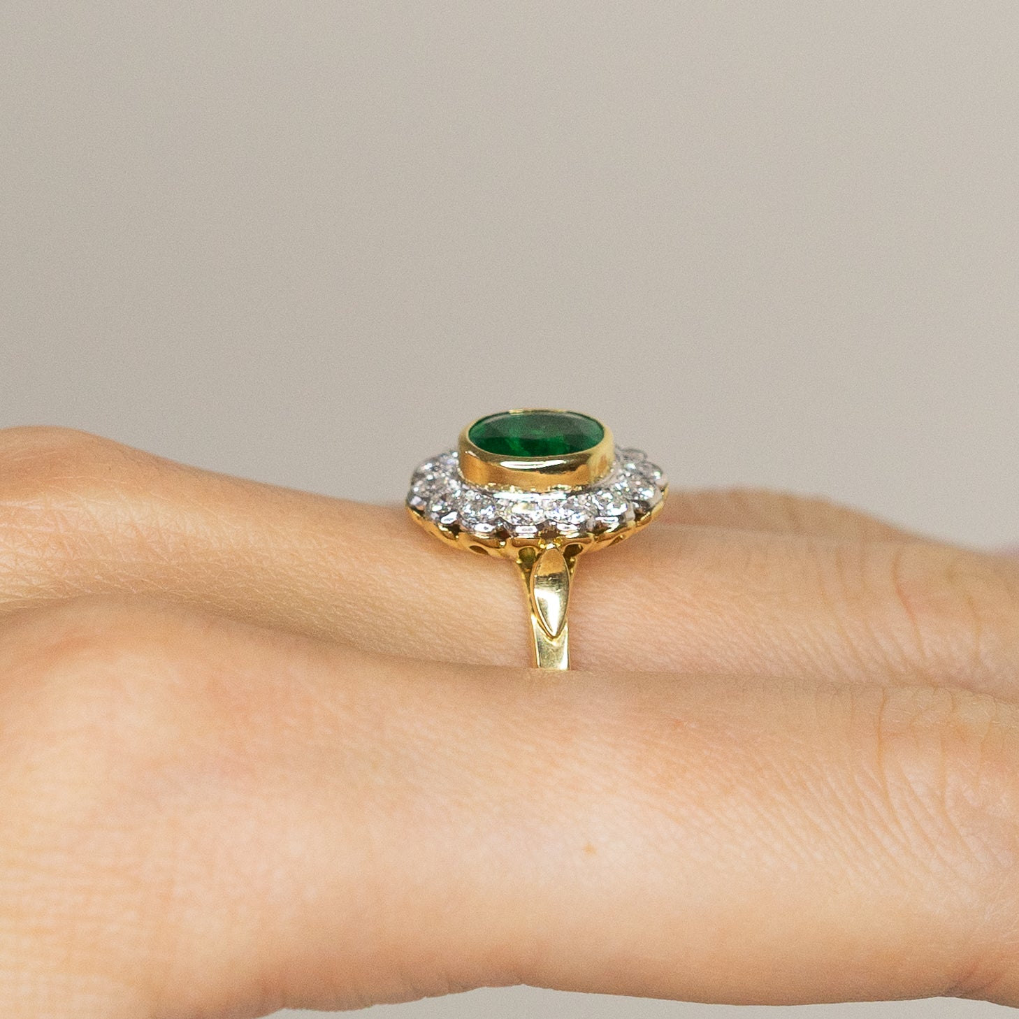 1.90ct Oval Emerald Ring with Bezel and Diamond Halo