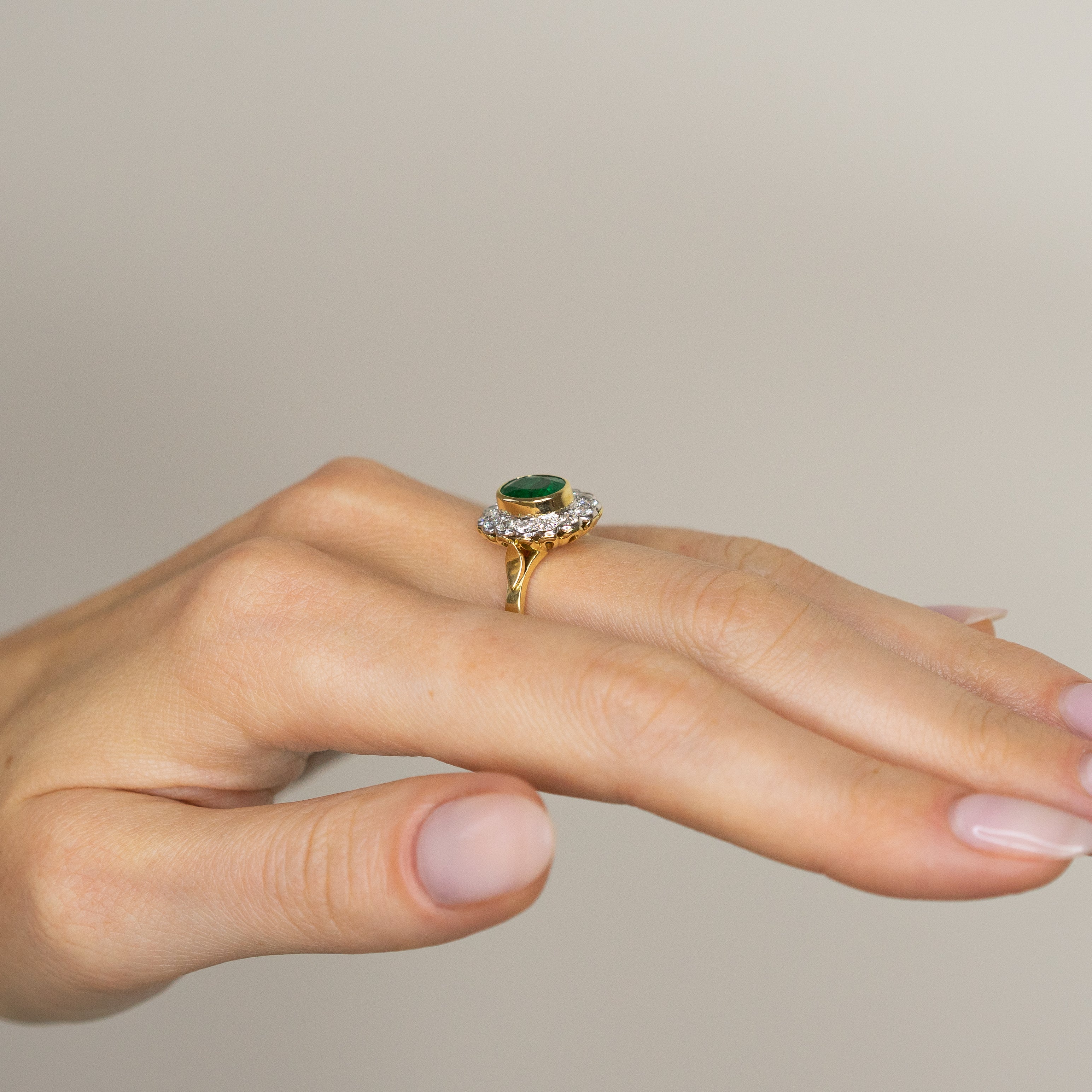 1.90ct Oval Emerald Ring with Bezel and Diamond Halo