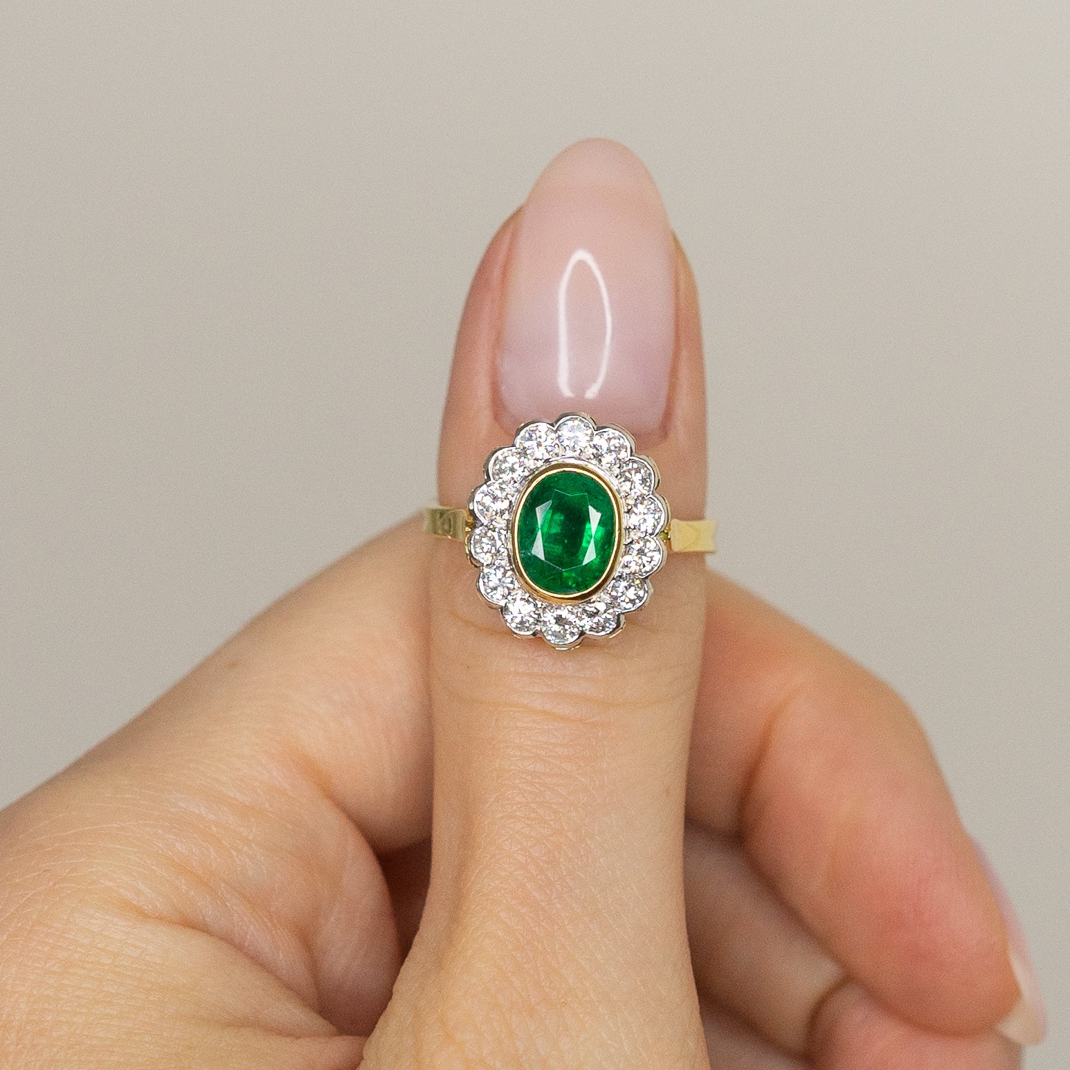 1.90ct Oval Emerald Ring with Bezel and Diamond Halo