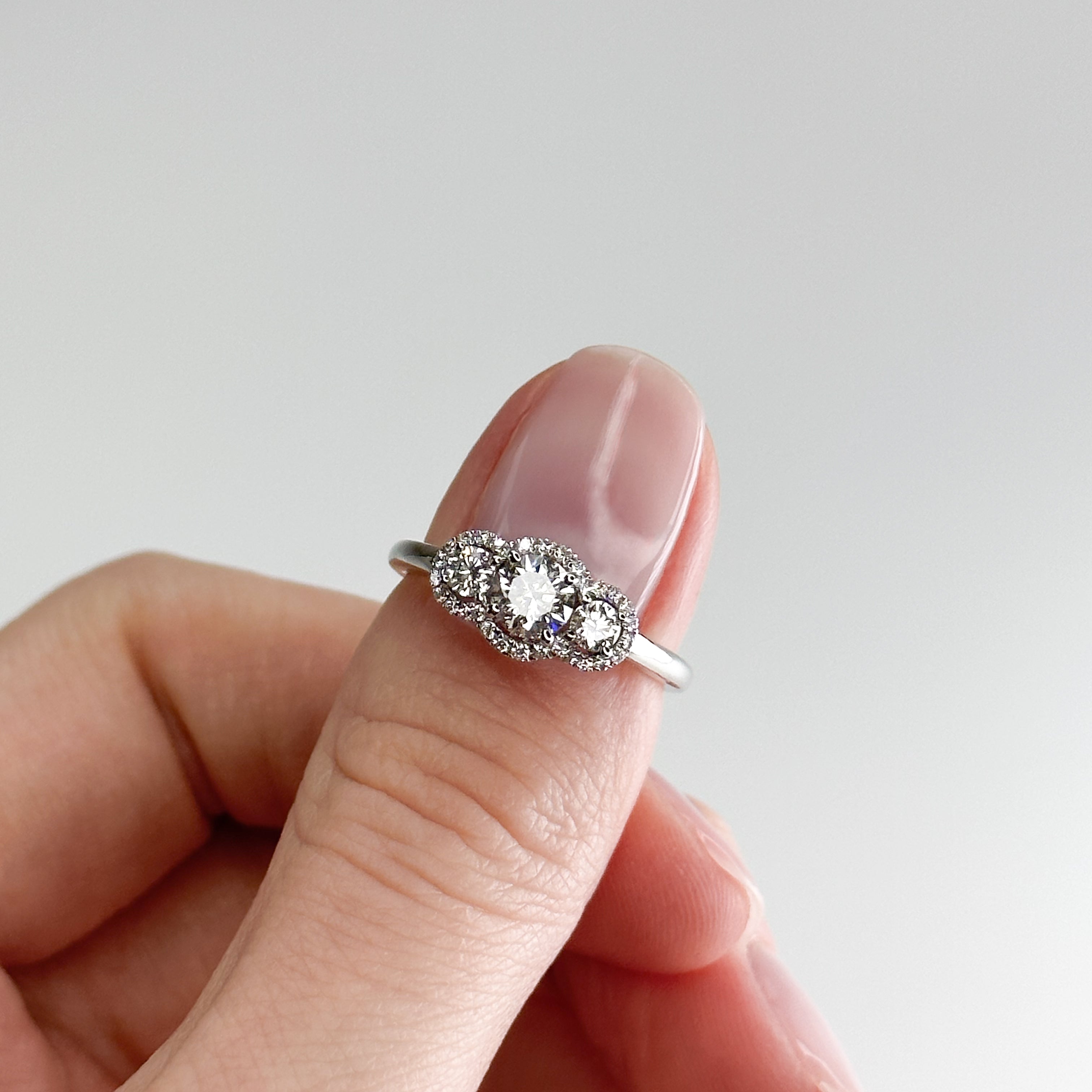 Diamond Trilogy Ring with 0.60ct Round Cut Stone