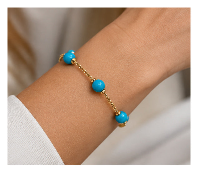 18ct yellow gold turquoise bead bracelet worn on wrist