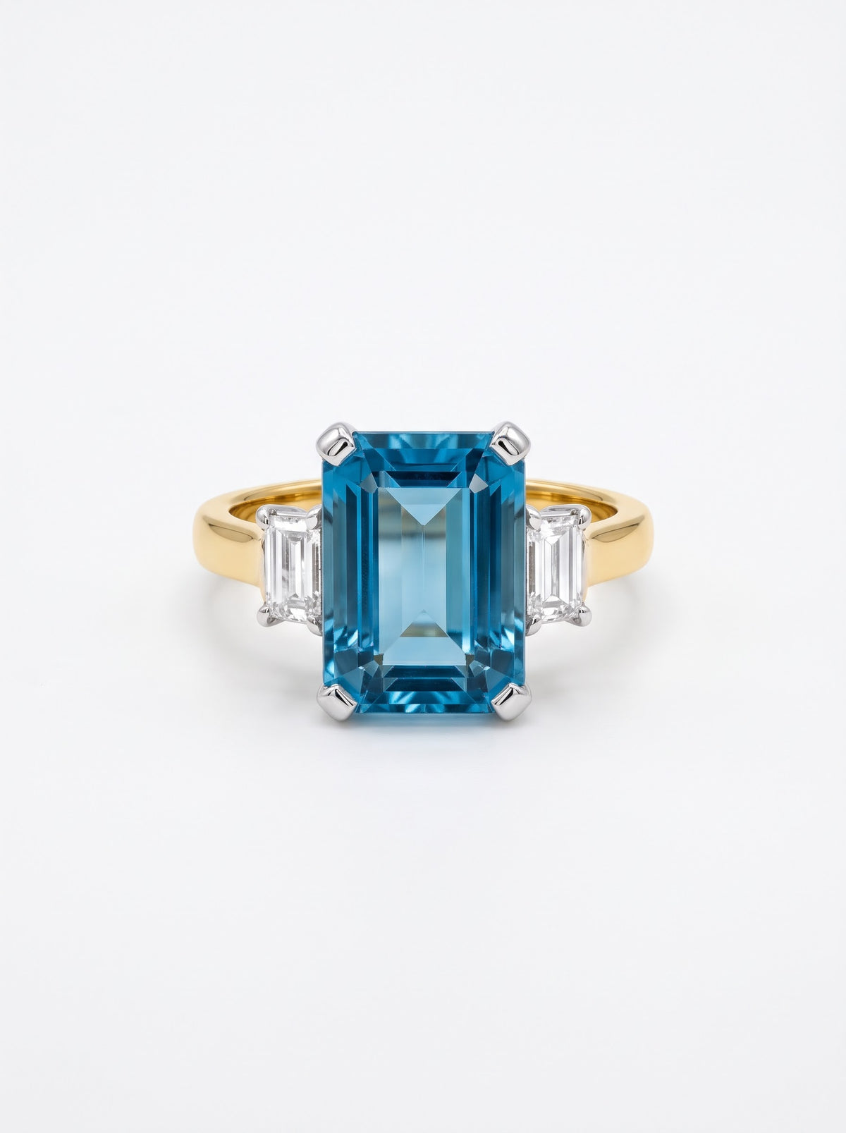 Pre-owned two-tone 18ct gold aquamarine and diamond three-stone ring front view on white