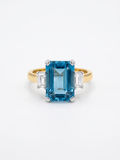 Pre-owned two-tone 18ct gold aquamarine and diamond three-stone ring front view on white