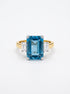 Pre-owned two-tone 18ct gold aquamarine and diamond three-stone ring front view on white