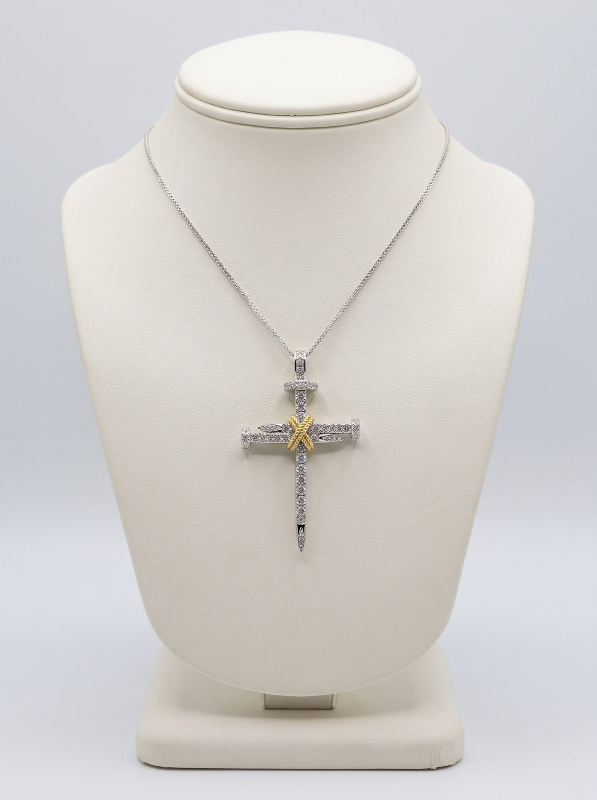 18ct white and yellow gold 1.05ct diamond nail cross necklace on ivory bust — main product image