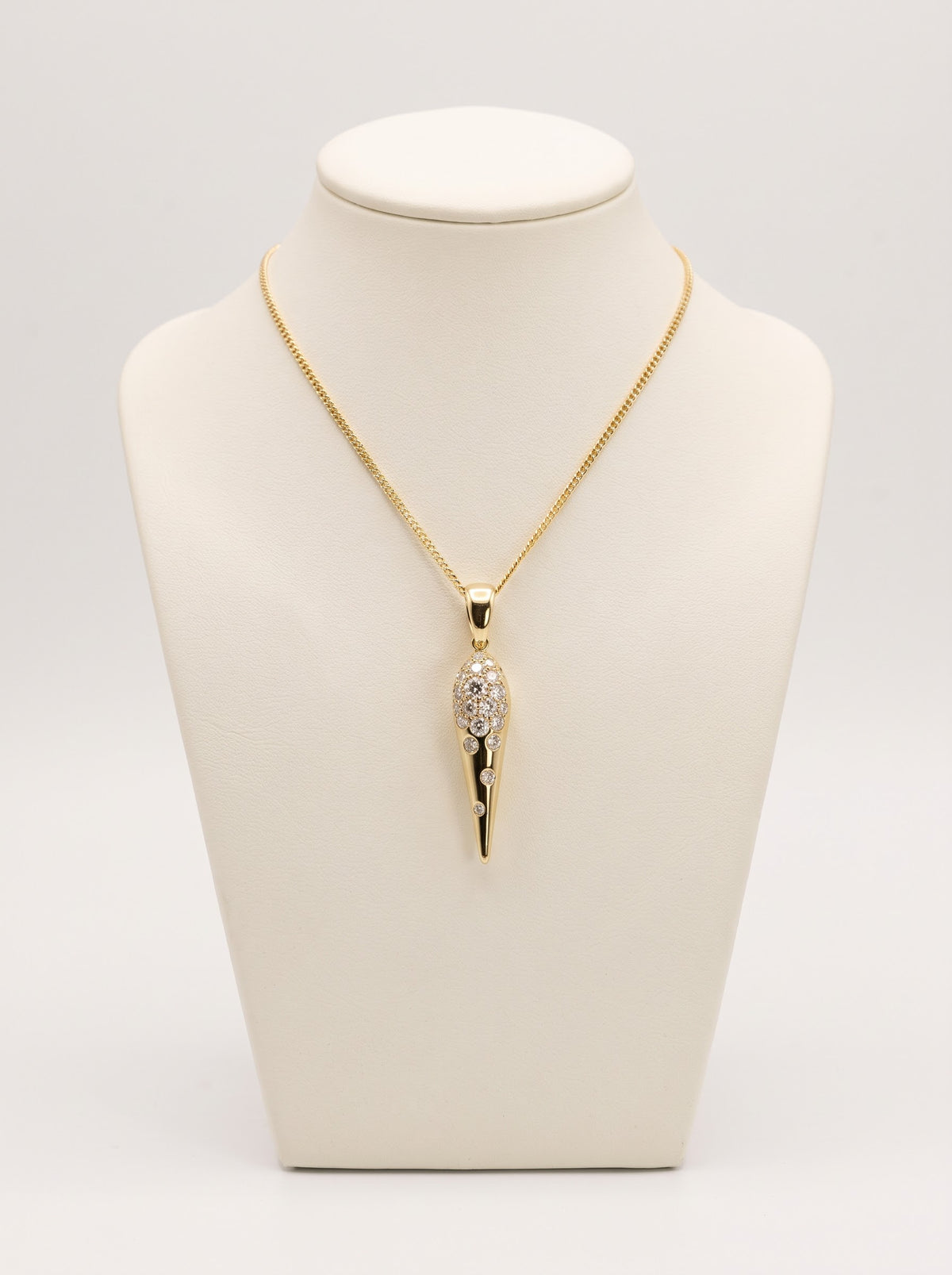 18ct yellow gold diamond tapered pendant on ivory jewellery bust