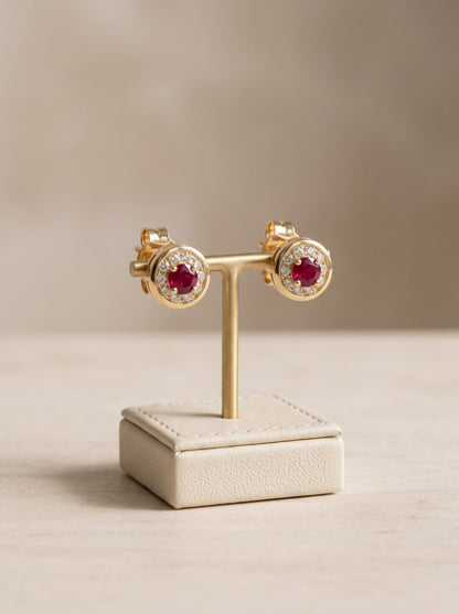 Vintage ruby and diamond halo stud earrings in 18ct yellow gold, on stand