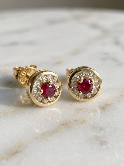 Close-up of ruby and diamond halo stud earrings
