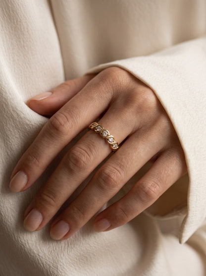 Pre-owned yellow gold seven-stone diamond ring worn on the hand