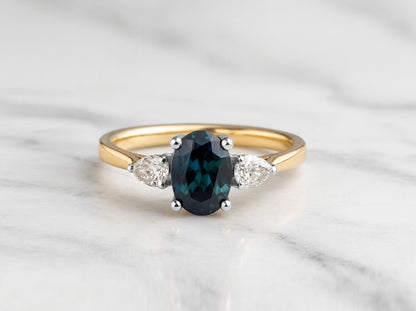 Oval cut Teal sapphire with pear diamonds