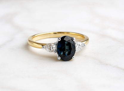 Oval cut Teal sapphire with pear diamonds