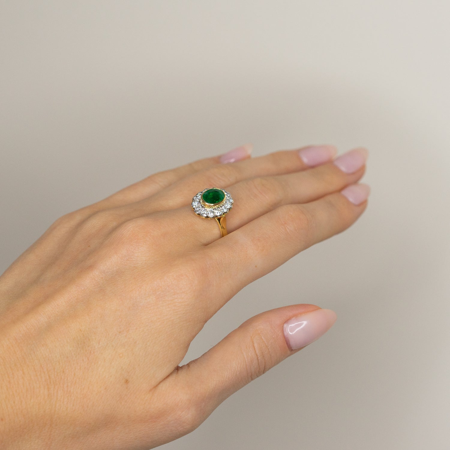 1.90ct Oval Emerald Ring with Bezel and Diamond Halo