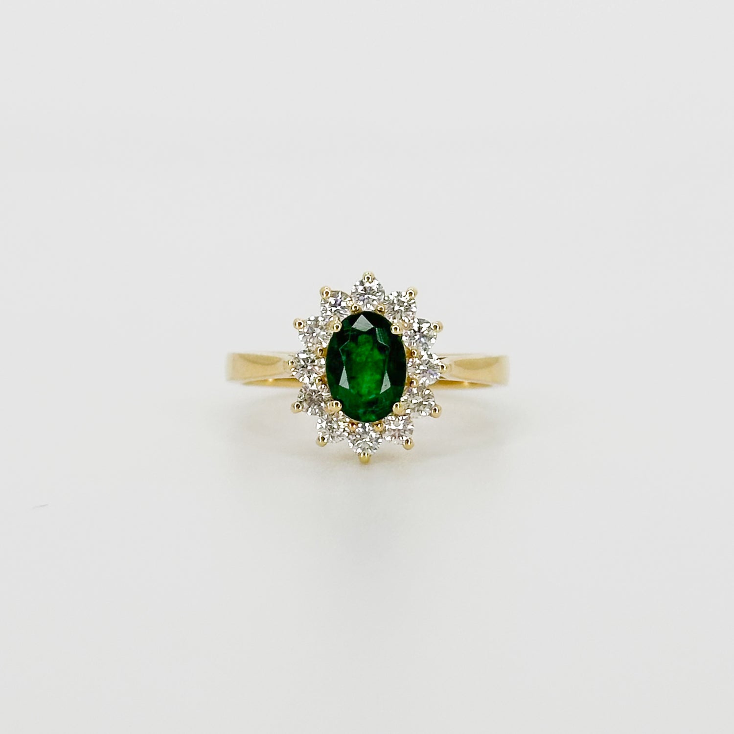 Deep Green Oval Cut Emerald Ring with Diamond Halo